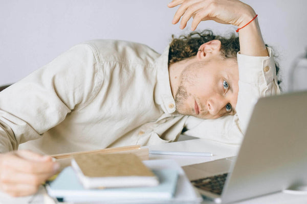 male creative entrepreneur overwhelmed with mental exhaustion