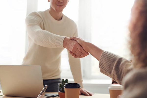 creative business owner shaking hands